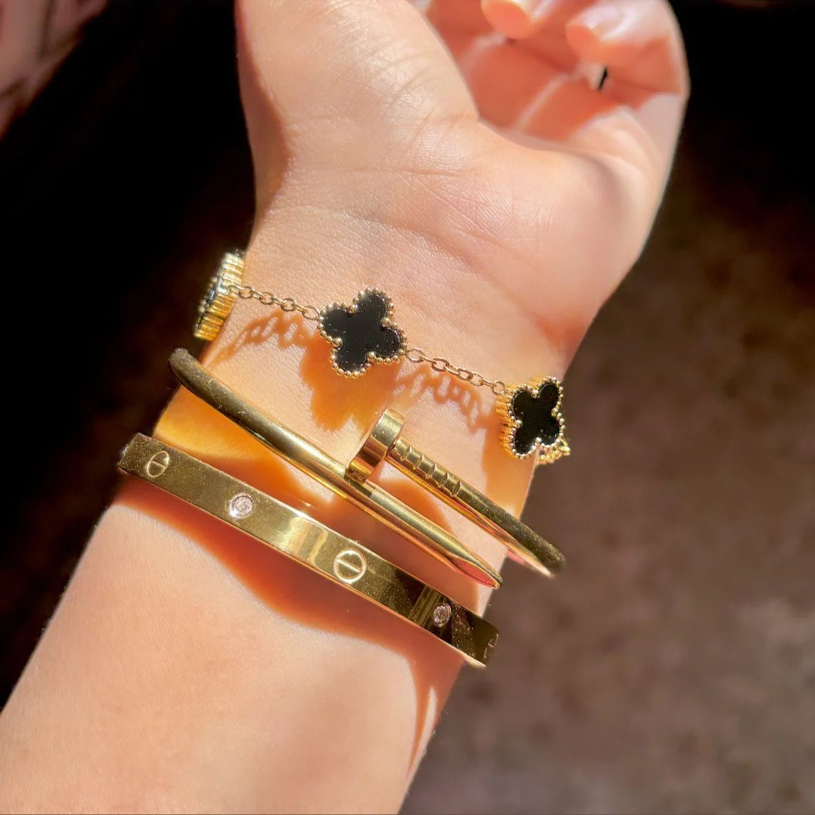Cartier Nail, love bangle with black clover bracelet ‘Stack’